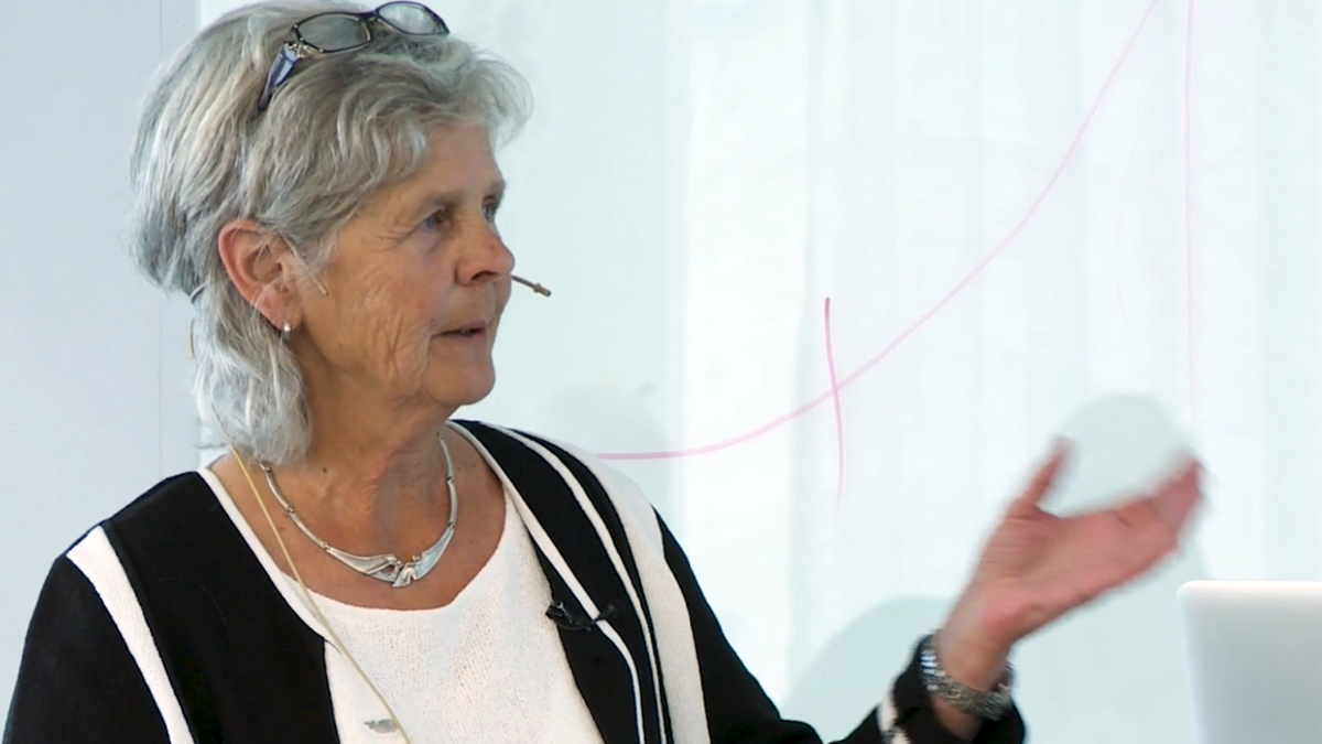 Person framför vit tavla med mikrofon av headsetvariant.