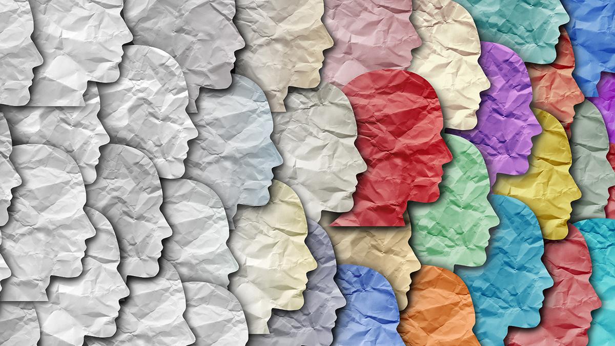 Utklippta papperssiluetter föreställande huvuden som går från grått till olika färger.